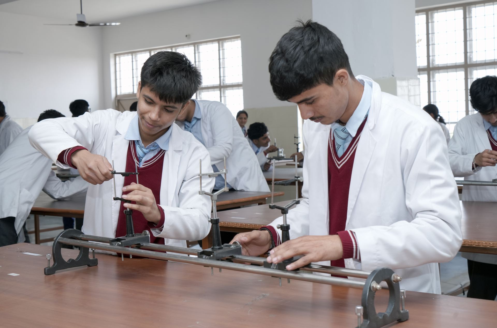 Students performing physics practical work in the laboratory